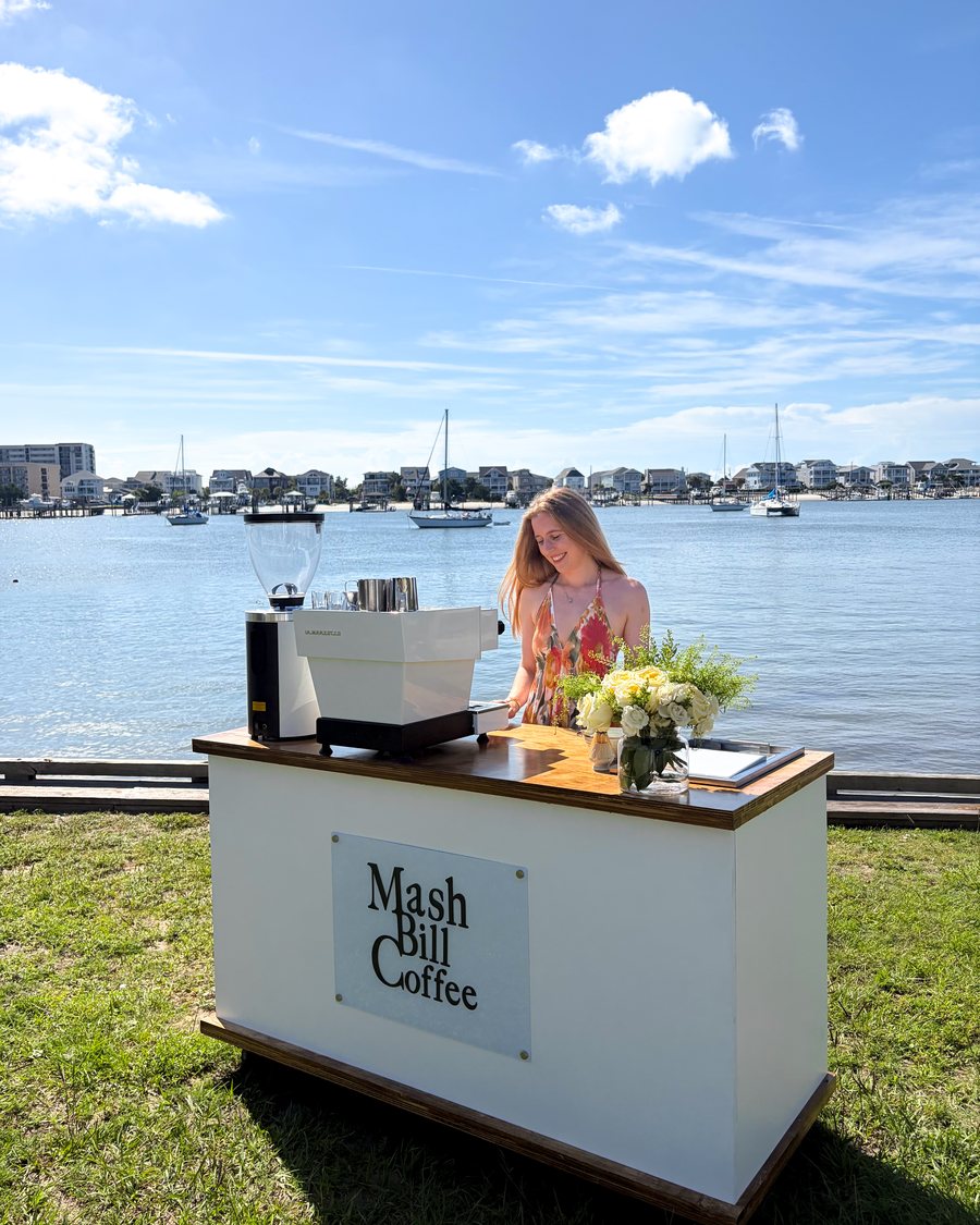 Ellen behind the Mash Bill Coffee cart on the waterfront lawn